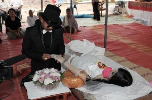 Chadil Deffy putting the wedding ring on the finger of his beloved girlfriend Sarinya Kamsook