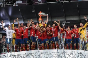 Spain defends Euro Title: Iberian players lifting the trophy in Kiev on July 1, 2012. (Football.ua via Wikimedia)