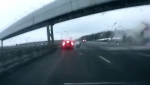 Driver breaks car before being hit by plane's wheel on Moscow freeway