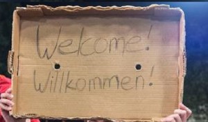 Arab migrants greeted by Germans with Welcome messages