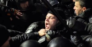 Policeman gasping for breath during Chisinau protests (capture: Youtube)